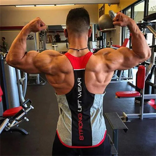 Muscular man flexing his arms in a gym wearing a 'Strong Lift Wear' tank top.