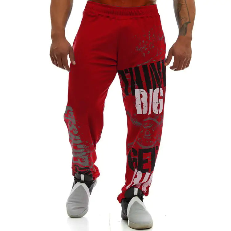 Red sweatpants with graphic designs on a white background