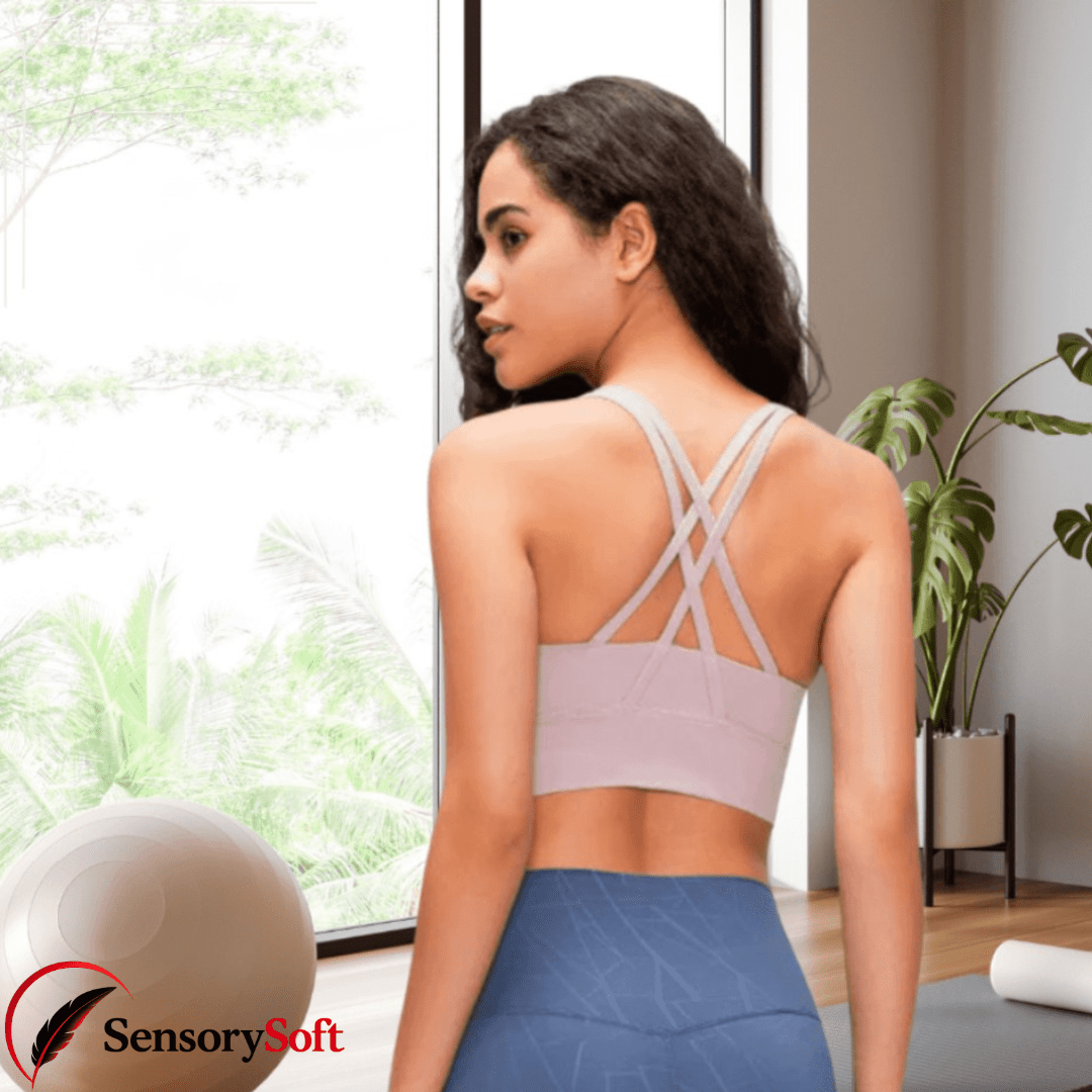 Woman in a sports bra and leggings standing in a bright room with plants