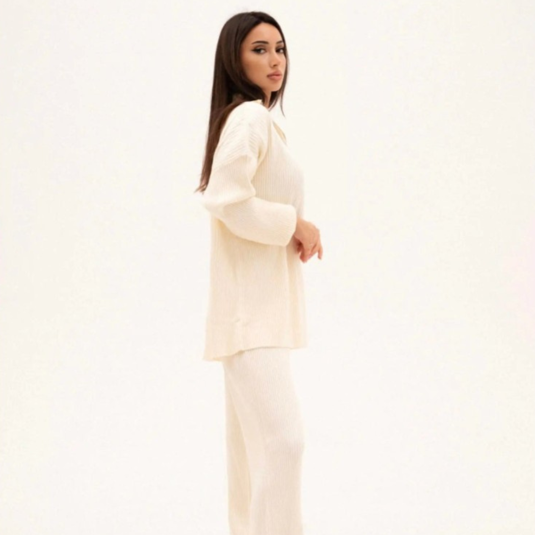 Woman wearing a cream-colored outfit on a white background