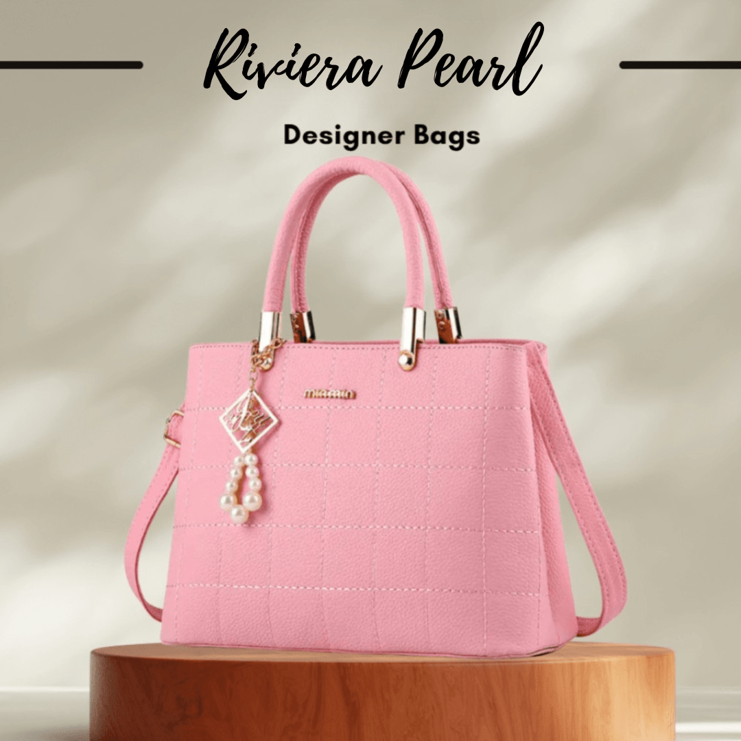 A pink designer handbag with a quilted texture, dual top handles, a detachable shoulder strap, and a pearl tassel charm, displayed on a wooden pedestal with 'Riviera Pearl Designer Bags' text at the top.