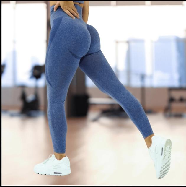 Person wearing blue leggings and white sneakers in an indoor setting