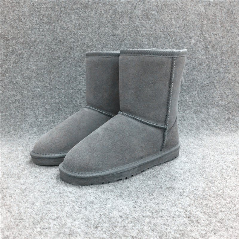 Pair of gray suede snow boots on a textured gray background