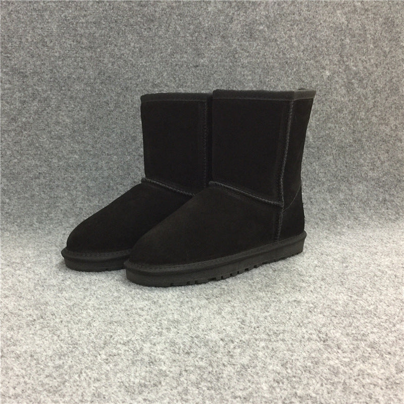 Black suede boots on a gray textured background
